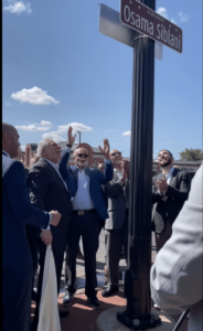 Siblani stands under the street sign that carries his name between County Executive Warren Evans (right) and his deputy, Assad Turfe, at the intersection of Warren Avenue and Chase Road, on Monday, September 8.